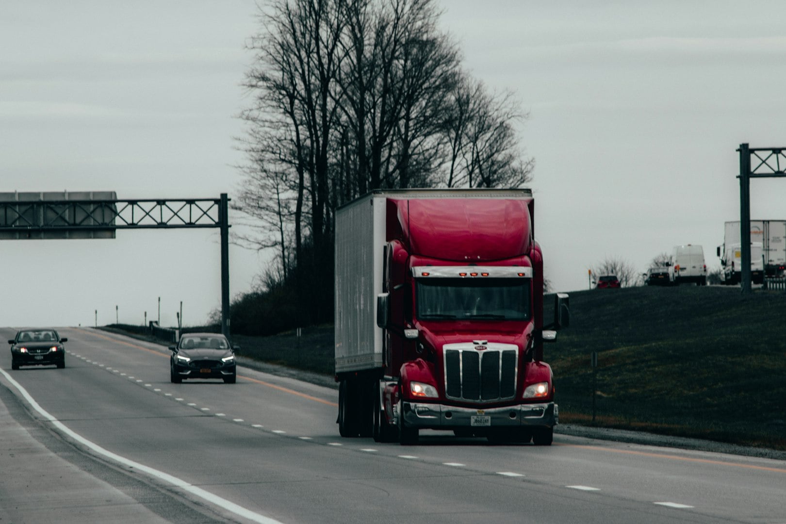 Delivery, container and happy truck driver moving industry cargo and freight at a shipping supply chain or warehouse. Smile, industrial and black man ready to transport ecommerce trade goods or stock